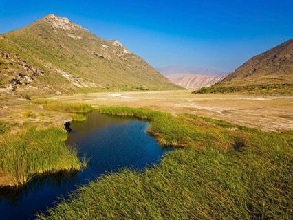 Landscape in Oman, mountains, Wadi Ashawq, road, reeds, waters Salalah, Al Mughsyal / Wadi Ashawq,