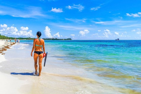 Sexy lady girl pretty woman walks on the tropical mexican beach with turquoise clear water on Playa