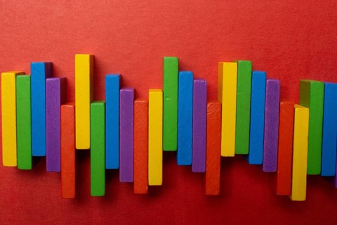 Colorful dominoes. Rainbow colored chain reaction
