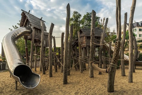 Children's playground with wooden huts, climbing equipment and slide, Bodman-Ludwigshafen,