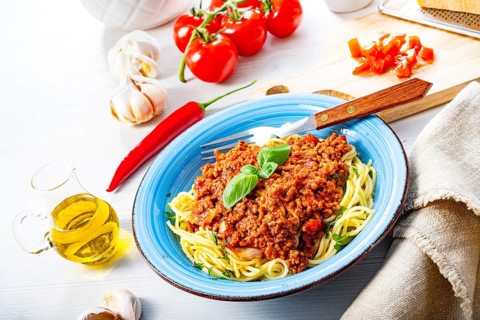 Delicious spaghetti bolognese on a white background