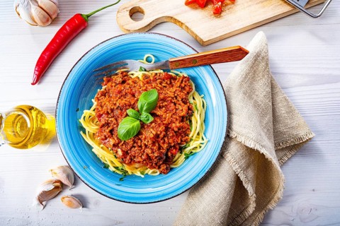 Delicious spaghetti bolognese on a white background