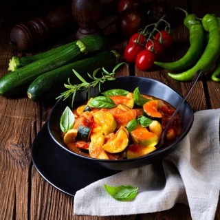 Vegetarian courgette ratatouille with tomato sauce and herbs