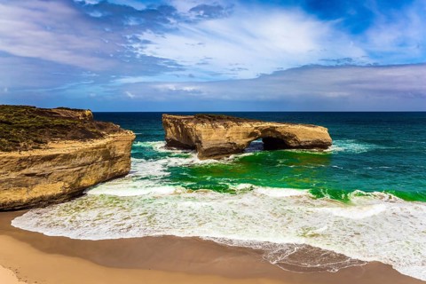 Fantastically picturesque Pacific coast of Australia. White surf foam and azure waves. The concept