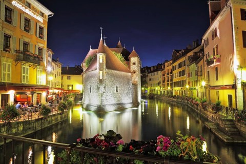 Old fortress-prison on the island. Castle illuminated by spotlights and is beautifully reflected in