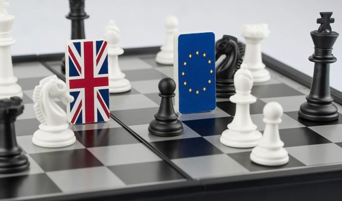 Chess pieces and flags of the European Union and the Britain on a chessboard. The concept of the