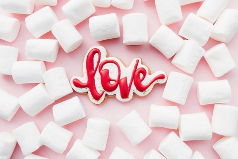Gingerbread cookies love with white marshmallow. Valentine card. Pink background.