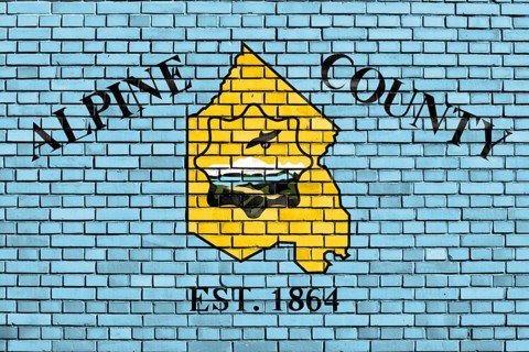 Flag of Alpine County, California painted on brick wall