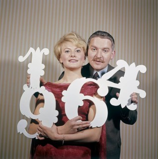 Fun with numbers in the 1960s. A woman and a man are holding different numbers in their hands 1, 4,