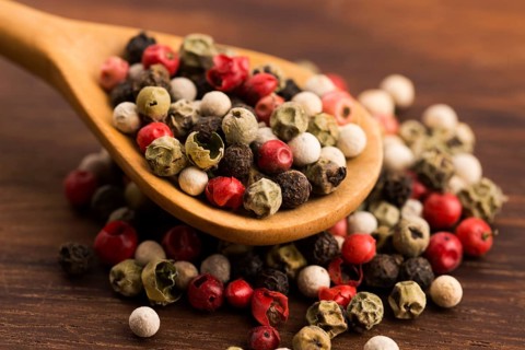 Mixed green, red, white and black peppercorns