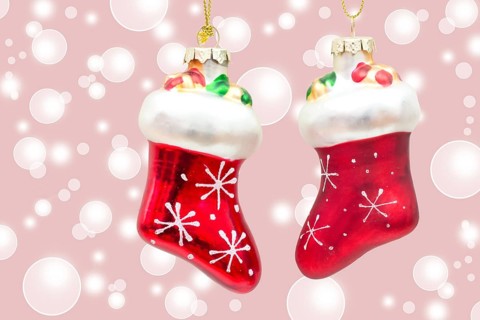 Two little red boots on pink bokeh background two little boots over pink bokeh background