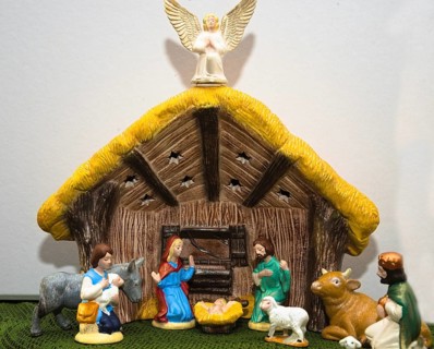 Nativity scene with painted figures of Christmas in the stable - close-up