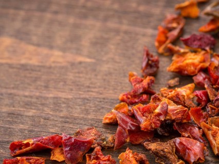 Cayenne pepper or paprika on wooden backround with copy space. Dry red pepper with copyspace