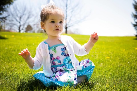 Pretty little girl playing in the grass during summer, Toronto, Canada, North America