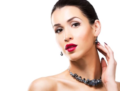Romantic woman with dramatic makeup and nailpolish. Big blue silver fashion necklace.