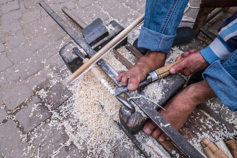 Craftsman carpenter working with his feet, street of the souk, marrakesh, morocco