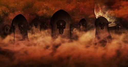 Cemetery At Night With Tombstones With Skulls And Burning Sky Full Of Clouds and Stars in The
