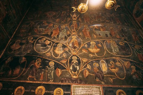 Church wall with paintings from the lives of the saints.