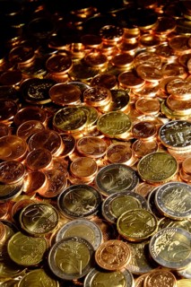 Euro coins of all denominations fill the motif. Portrait format. Euros of all coin values fill in