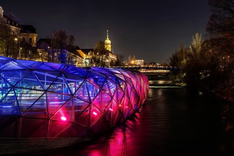 Illuminated Mur Island, behind the tower of the Franciscan Church, night shot, Graz, Styria,