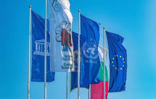 The Flags of European Union, United Nations, Unesco, Bulgaria, and Nessebar city waving in the wind