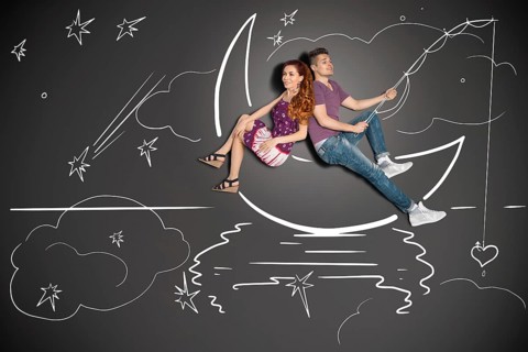 Happy valentines love story concept of a romantic couple fishing on a moon with a heart on a hook