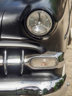Close-up of a black classic car with focus on the headlights and chrome, Duisburg, Ruhr area,