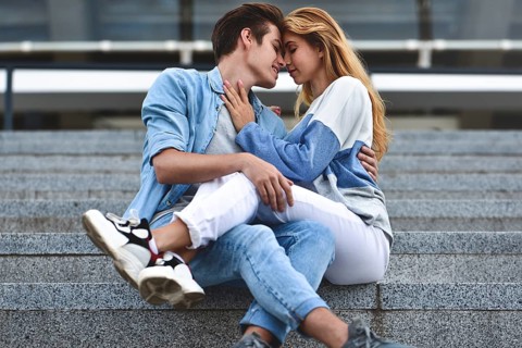 Happy to spending time together. Young beautiful couple outdoor fashion portrait. Attractive boy