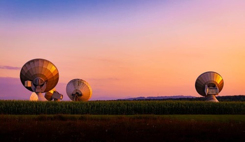 Large parabolic antenna at dusk