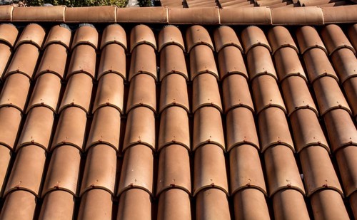 Tiles on old castle roof, architecture background. Brown roof tiles