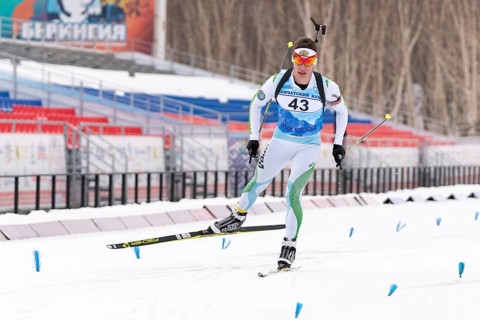 Sportsman biathlete Zlobin Vladislav Khanty-Mansiysk skiing on distance biathlon stadium. Open