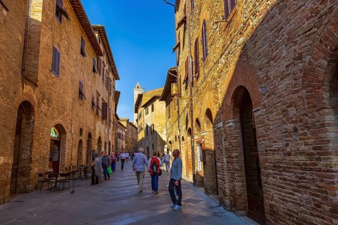 San Gimignano, Tuscany, Italy, October 25, 2018: Old medeival street and tower in typical Tuscan