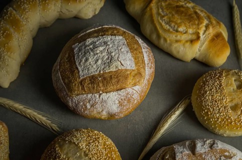 Beautiful Sourdough bread on gray background with dried wheat flower