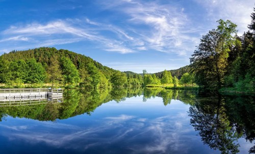 Beautiful reflection of a lake in the Spiesswoogtal valley near the German village Fischbach bei