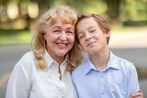 Teenager boy is happy to spend time with grandma. Family portrait is full of happiness and warmth