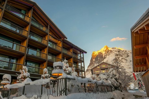 House and Mountain Peak in the Swiss Alps in a Snowy Winter Day in Grindelwald, Canton Bern,