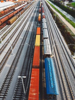 Cargo trains close-up. Aerial view of colorful freight trains on the railway station. Wagons with