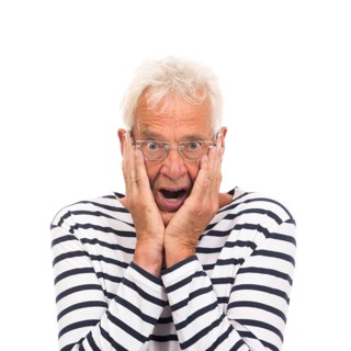 Scaring senior man with glasses isolated over white background
