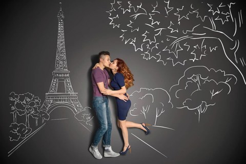 Happy valentines love story concept of a romantic couple in Paris kissing under the Eiffel Tower