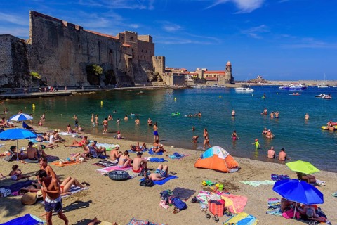 People having fun on the beach in summer in Collioure, France, Europe