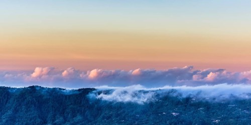Amazing panorama view on clouds above mountain from summit of Batur volcano, Bali, Indonesia, Asia