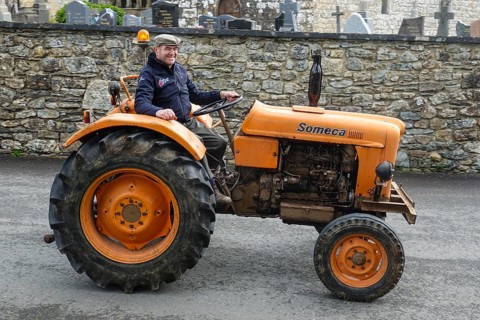 Old tractor Someca in front of church and chapel Sainte Nonne, vintage car meeting Dirinon,