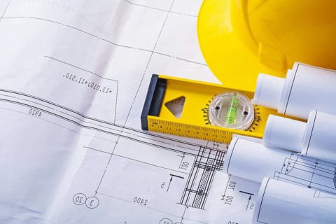 Copyspace image rolled blueprints level helmet