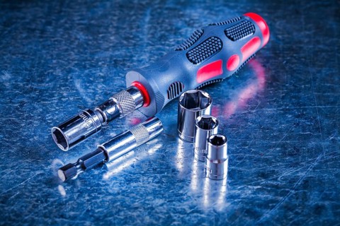 Screwdriver bit holders replaceable torxes on scratched metallic background construction concept