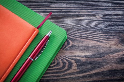 Diary books brio pen on wooden board education concept