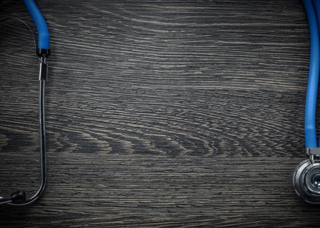 Stethoscope on vintage wooden board medicine concept