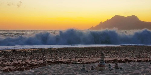 Surf wave at sunset on the beach in Porto, Corsica