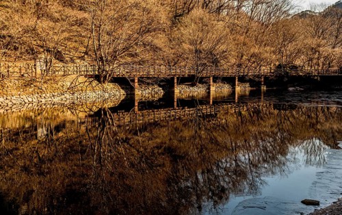 Jeongeup-si, South Korea. December 8, 2020: Winter landscape of bridge reflecting in water of