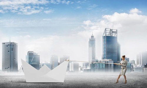 Successful businesswoman pulling with rope paper boat