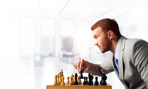 Businessman moving chess figure in chessboard. Successful management and leadership concept.